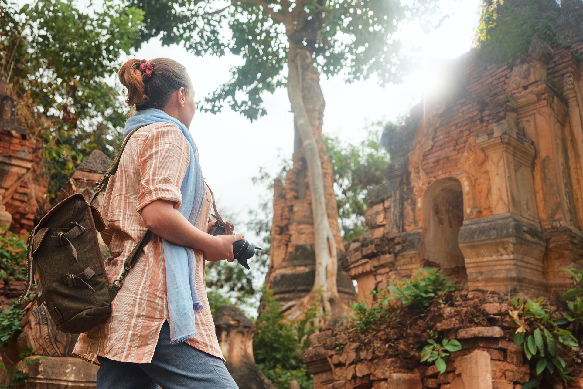 Traveller with backpack explore at Buddhist ancient temple and stupas in Indein. Myanmar